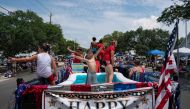 Residents participate in the annual Independence Day Parade on July 4, 2023 in Southport, North Carolina. (Photo by Allison Joyce / Getty Images via AFP)

