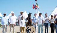 QOC President and Chairman of Al Shaqab H E Sheikh Joaan bin Hamad Al Thani along with other officials poses with Al Shaqab’s medal winning horse.  