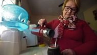 Uruguayan retired housewife Isabel Moreira pours hot water in her mate at her house in Montevideo on July 10, 2023, amid a severe drought that caused a water crisis in the country. (Photo by Dante Fernandez / AFP)