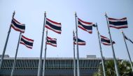 (Files) This file picture taken on March 4, 2023, shows Thai national flags on the side of the Parliament complex in Bangkok, the meeting place of the National Assembly of Thailand. (Photo by Amaury Paul / AFP)

