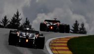 Red Bull Racing's Dutch driver Max Verstappen (R) and Alpha Tauri's Japanese driver Yuki Tsunoda compete during the sprint shootout ahead of the Formula One Belgian Grand Prix at the Spa-Francorchamps Circuit in Spa on July 29, 2023. (Photo by John Thys / AFP)