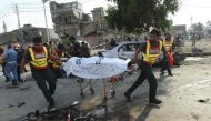 File photo of Pakistani rescue workers move the body of a victim at the site of an explosion in Lahore on July 24, 2017. (AFP / ARIF ALI)