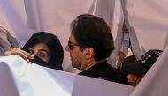 File photo: Former Pakistan prime minister Imran Khan with his wife Bushra Bibi arrive to appear at a high court in Lahore on May 15, 2023. (Photo by Arif Ali / AFP)

