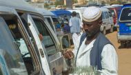 (Files) A street vendor sells tea at a bus station in Madani on May 16, 2023. (Photo by AFP)