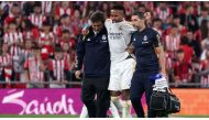 Real Madrid's Brazilian defender #03 Eder Militao is helped to leave the pitch after resulting injured during the Spanish Liga football match between Athletic Bilbao and Real Madrid at the San Mames stadium in Bilbao on August 12, 2023. (Photo by CESAR MANSO / AFP)