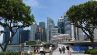 In this file photo taken on April 24, 2023 people walk across Jubilee Bridge at Marina Bay in Singapore. Photo by Roslan RAHMAN / AFP

