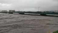 The Sendai River swollen due to heavy rains is pictured in the city of Tottori, Tottori prefecture on August 15, 2023. (Photo by Jiji Press / AFP) 