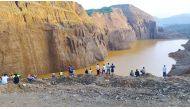 This photo taken on August 13, 2023 and received courtesy of Tarlin Mg via Facebook on August 14 shows people looking at the site of a deadly landslide at an unregulated jade mine near northern Kachin's Hpakant township. (Photo by Tarlin MG / UGC / AFP) 
