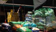 A volunteer points to a bag of donated pet foods at the Maui Humane Society in Puunene, central Maui, Hawaii on August 15, 2023. Photo by Yuki IWAMURA / AFP