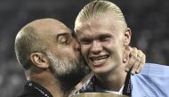 Manchester City's Spanish manager Pep Guardiola (left) kisses Manchester City's Norwegian striker Erling Haaland after winning the 2023 UEFA Super Cup football match between Manchester City and Sevilla at the Georgios Karaiskakis Stadium in Piraeus on August 16, 2023. (Photo by Spyros Bakalis / AFP)
