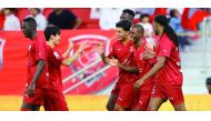Al Duhail's Ibrahima Diallo (second right) celebrates with teammates
