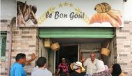 People queue in front of a bakery selling subsidised bread in Tunis' Halfaouine district, on August 19, 2023. (Photo by HASNA / AFP)
