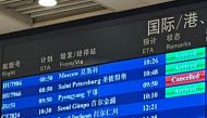 The cancelled status of an Air Koryo flight from North Korea's capital Pyongyang is seen in red on an information board at Beijing Capital international airport on August 21, 2023. (Photo by Oliver Hotham / AFP)