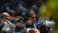 File photo: Policemen escort Pakistan's former Prime Minister Imran Khan (centre) as he arrives at the high court in Islamabad on May 12, 2023. (Photo by Aamir Qureshi / AFP)
