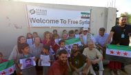 A delegation of US representatives poses for a picture with orphaned children during their visit to a hospital in Syria's border town of Azaz, in the north of Aleppo province, on August 27, 2023. (Photo by Bakr Alkasem / AFP)