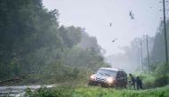 People work to free a vehicle stuck on the shoulder amid storm debris as Hurricane Idalia crosses the state on August 30, 2023 near Mayo, Florida. (Photo by Sean Rayford / GETTY IMAGES NORTH AMERICA / Getty Images via AFP)

