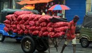 A labourer pulls a cart carrying sacks of onions at a market in Colombo on September 1, 2023. Photo by AFP