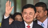 File photo: Former Thai Prime Minister Thaksin Shinawatra greets his supporters after landing at Bangkok's Don Mueang airport on August 22, 2023. (Photo by Lillian Suwanrumpha / AFP)