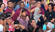 Presidential candidate Tharman Shanmugaratnam (centre) meets his supporters while waiting for the Presidential election results in Singapore on September 1, 2023. (Photo by Roslan RAHMAN / AFP)