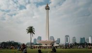 People gather in the park of the National Monument (Monas) in Jakarta on August 6, 2023. Photo by Yasuyoshi CHIBA / AFP

