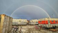 This handout image provided courtesy of Josh Lease on September 3, 2023 shows a double rainbow over flooding on a desert plain on September 1, 2023, after heavy rains turned the annual Burning Man festival site in Nevada's Black Rock desert into a mud pit. (Photo by Josh Lease / UGC / AFP) 