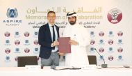 QFA Secretary General Mansour Al Ansari and Director General of the Aspire Academy Ivan Bravo pose for a photo after the signing ceremony. 