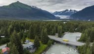A bus crosses over the Mendenhall River on Aug. 8 in Juneau. Mendenhall Glacier is seen on the horizon. All photos for The Washington Post by Christopher S. Miller