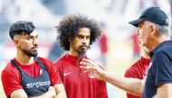 Qatar coach Carlos Queiroz (right) speaks to Akram Afif and Tarek Salman.
