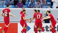 Qatar’s forward Ahmed Alaaeldin celebrates with teammates after scoring a goal against Russia. AFP