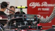 Mechanics work on the car of Alfa Romeo's Chinese driver Zhou Guanyu ahead of the Singapore Formula One Grand Prix night race at the Marina Bay Street Circuit in Singapore on September 14, 2023. (Photo by MOHD RASFAN / AFP)