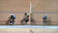 India's David Beckham Elkatohchoongo (L) and Kazakhstan's Sergey Ponomaryov (R) compete in the men's sprint 1/16 finals of the cycling track event during the 2022 Asian Games in Hangzhou in China's eastern Zhejiang province on September 27, 2023. (Photo by Jung Yeon-je / AFP)