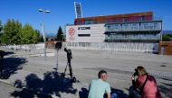 Journalists wait outside the Spanish football federation headquarters where a judge on September 28, 2023 has ordered a police search at the headquarters of the Spanish refereeing committee, in Las Rozas de Madrid. (Photo by JAVIER SORIANO / AFP)

