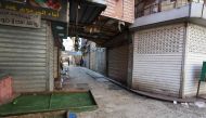 Palestinian youths stand in front of shuttered shops during a general strike in Nablus in the occupied West Bank, on October 18, 2023, a day after a rocket hit a Gaza hospital killing hundreds. (Photo by Zain JAAFAR / AFP)