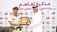 QFA President Jassim bin Rashid Al Buenain presents a memento to NSA’s Major General Hamad bin Ahmed Al Nuaimi after signing the MoU yesterday.   