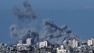 Smoke rising behind destroyed buildings in the north-western part of the Palestine during an Israeli bombing on October 21, 2023. (Photo by Aris Messinis / AFP)