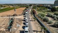 This aerial view shows humanitarian aid trucks arriving from Egypt after having crossed through the Rafah border crossing arriving at a storage facility in Khan Yunis in the southern Gaza Strip on October 21, 2023. Photo by Belal Al SABBAGH / AFP