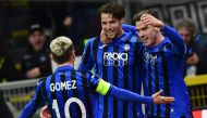 Atalanta's Dutch defender Hans Hateboer (C) celebrates with Atalanta's Argentinian forward Papu Gomez (L) and Atalanta's German defender Robin Gosens after opening the scoring during the UEFA Champions League round of 16 first leg football match Atalanta


