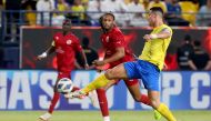 Al Duhail’s Ruben Semedo (centre) and Al Nassr’s Cristiano Ronaldo in action. AFP