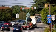 The statue of Confederate General Robert E. Lee is driven away from a park after being removed in Charlottesville, Virginia on July 10, 2021. (Photo by Ryan M. Kelly / AFP)