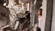 A man stands amid the rubble of a building in the aftermath of Israeli bombing in Rafah in the southern Gaza Strip on October 29, 2023. Photo by MOHAMMED ABED / AFP