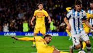 Barcelona's Uruguayan defender #04 Ronald Araujo vies with Real Sociedad's Spanish defender #03 Aihen Munoz during the Spanish league football match in San Sebastian on November 4, 2023. (Photo by Ander Gillenea / AFP)