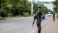 Colombian Army members stand guard at a checkpoint in Barrancas, La Guajira, Colombia on November 6, 2023. (Photo by Lismari Machado / AFP)
