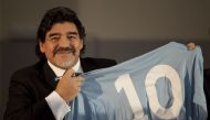 In this file photo taken on February 26, 2013, football legend Argentinian Diego Maradona holds a SSC Napoli number 10 jersey during a press conference in Naples. (AFP)

