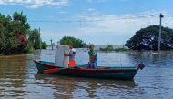 Handout picture released by Argentina's Social Development via Telam showing locals using boats to move around and salvage belongings in Santo Tome, Corrientes Province, Argentina, on the border with Brazil, on November 6, 2023. (Photo by Argentina's Social Development Ministry / AFP) 
