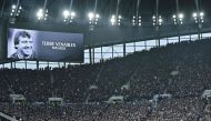 A picture of former England player and coach Terry Venables is shown on the video screen as team players a members of the public pay a tribute for him following the announcement of his passing away prior to the English Premier League football match between Tottenham Hotspur and Aston Villa at Tottenham Hotspur Stadium in London, on November 26, 2023. (Photo by Ben Stansall / AFP) 