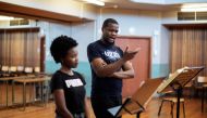 Final year graduate opera student Yonwaba Mbo (C) and first year post graduate opera student Siphosihle Letsoso (L) practice during a rehearsal of Mozart's Le Nozze Di Figaro at the University of Cape Town (UCT) School of Music in Cape Town on November 15, 2023. Photo by GIANLUIGI GUERCIA / AFP