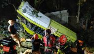 This handout photo taken on December 5, 2023 and released on December 6 by the Iloilo City Disaster Risk Reduction and Management Office shows rescue personnel working at the scene where a bus plunged into a ravine in Hamtic town, Antique province, central Philippines. Photos by Handout / ILOILO CITY DISASTER RISK REDUCTION AND MANAGEMENT OFFICE / AFP