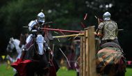 (Files) Chris Sailing as 'The Wyvern' (L) and Ben Green as 'The Wildman' compete on their horses during the Legendary Joust jousting event at English Heritage's Kenilworth Castle, near Coventry, central England on July 29, 2023. (Photo by Oli Scarff / AFP) 