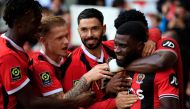Nice's Ivorian forward #07 Jeremie Boga (R) celebrates with teammates after scoring his team's second goal during the French L1 football match between OGC Nice and Stade de Reims at the Allianz Riviera Stadium in Nice, south-eastern France, on December 10, 2023. (Photo by Valery HACHE / AFP)