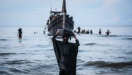 A Newly arrived Rohingya refugee walks to the beach after the local community decided to temporarily allow them to land for water and food in Ulee Madon, Aceh province, Indonesia, on November 16, 2023. (Photo by amanda jufrian / AFP)